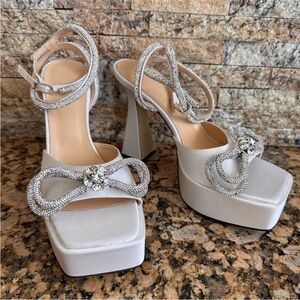 MACH & MACH 140 CRYSTAL DOUBLE BOW PLATFORM SANDALS IN SATIN